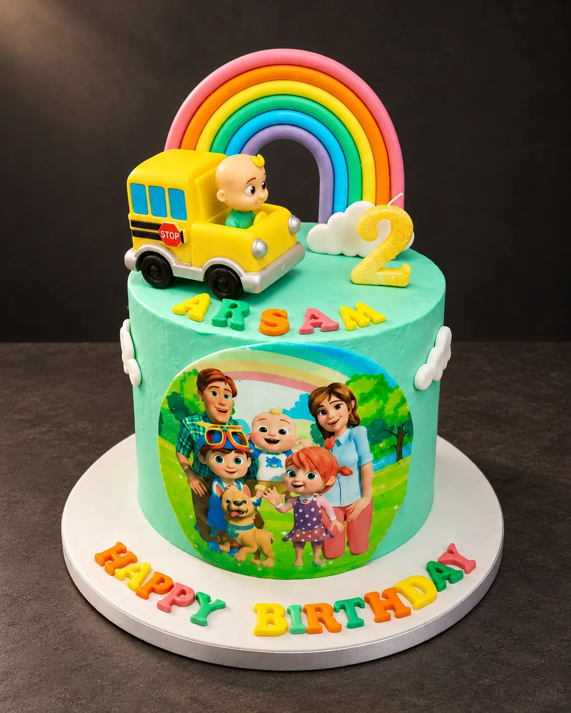 Rainbow cake with a toy bus