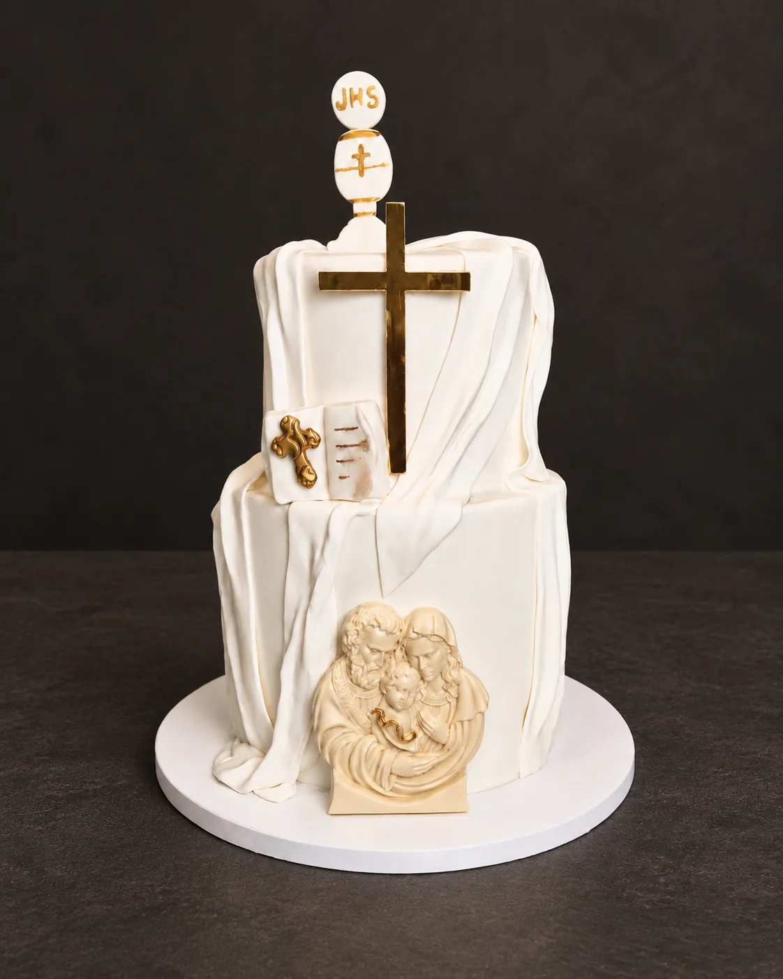 White tiered cake with a gold cross